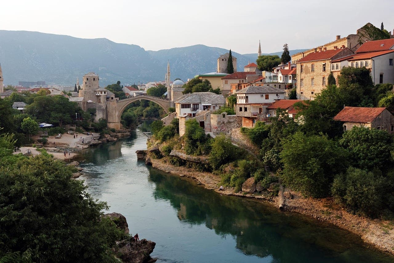The Ottoman-era Stari Most stone bridge arching over the emerald Neretva River in Mostar