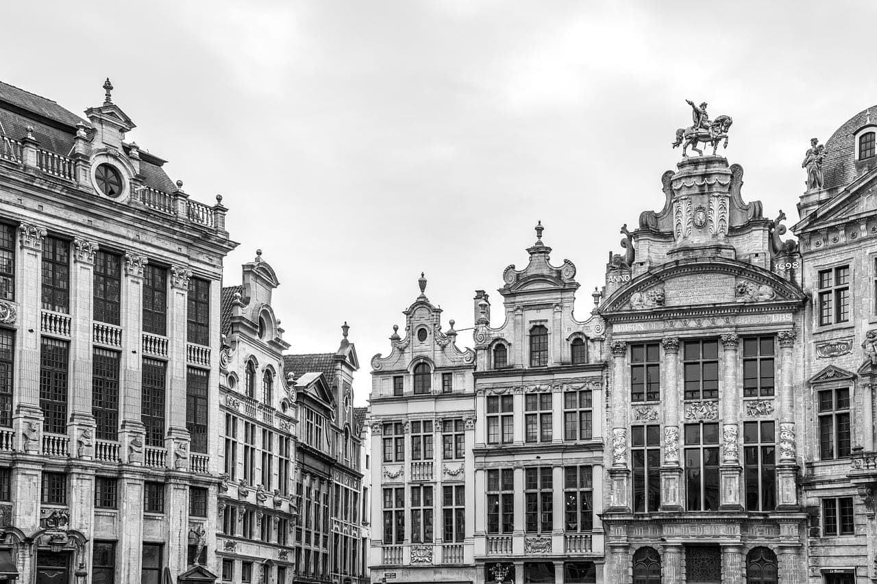 Floodlit gothic guildhall facades on Brussels' central square at dusk
