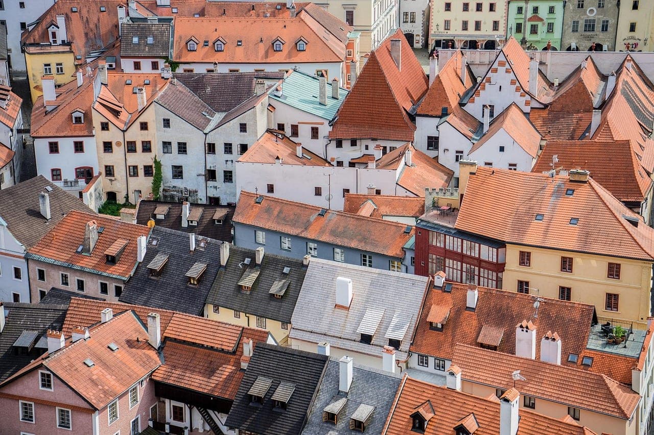 Medieval Bohemian town of Cesky Krumlov above a bend in the Vltava River with castle tower and red rooftops