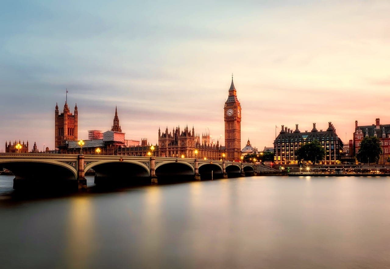 Big Ben and the Houses of Parliament lit at dusk above the River Thames in London