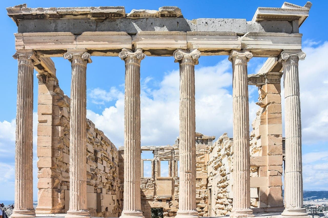 Parthenon and Acropolis of Athens glowing above the city at sunset in Greece