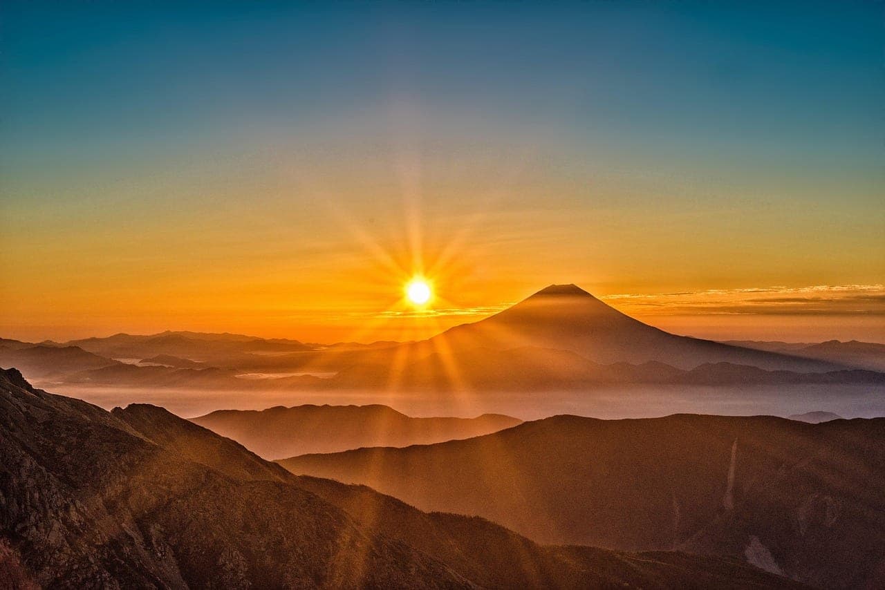Mount Fuji rising beyond a pagoda and cherry blossoms in spring Japan