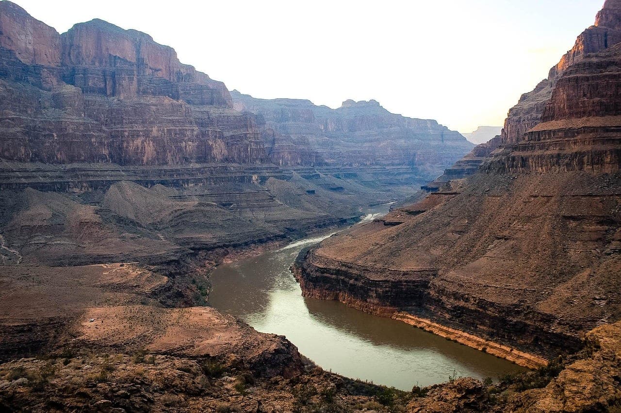 Sunlit layered rock formations of the Grand Canyon at sunrise in the American Southwest