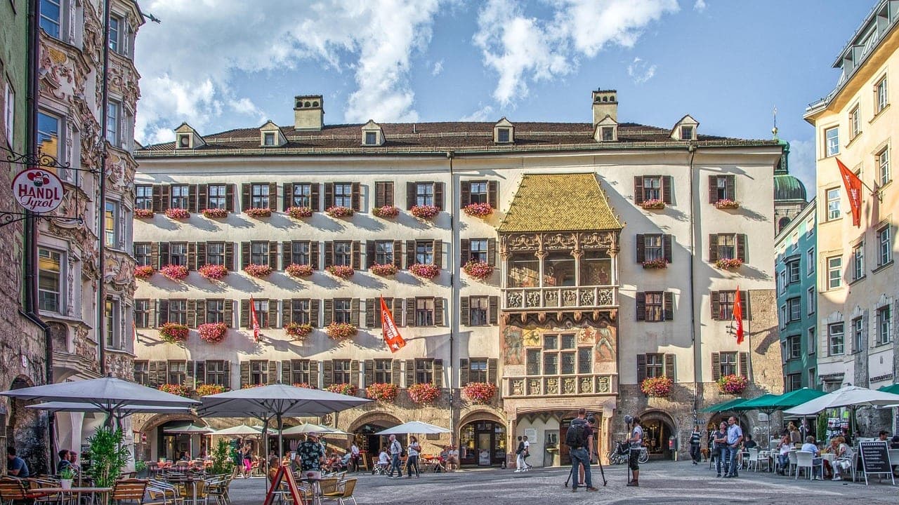 Pastel Old Town buildings of Innsbruck framed by snow-capped Nordkette Alps in Tyrol Austria