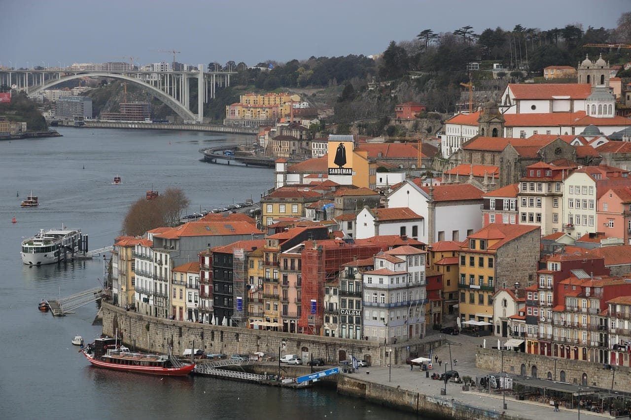 Colorful tile-fronted houses tumbling down to the Douro river along Porto's Ribeira waterfront