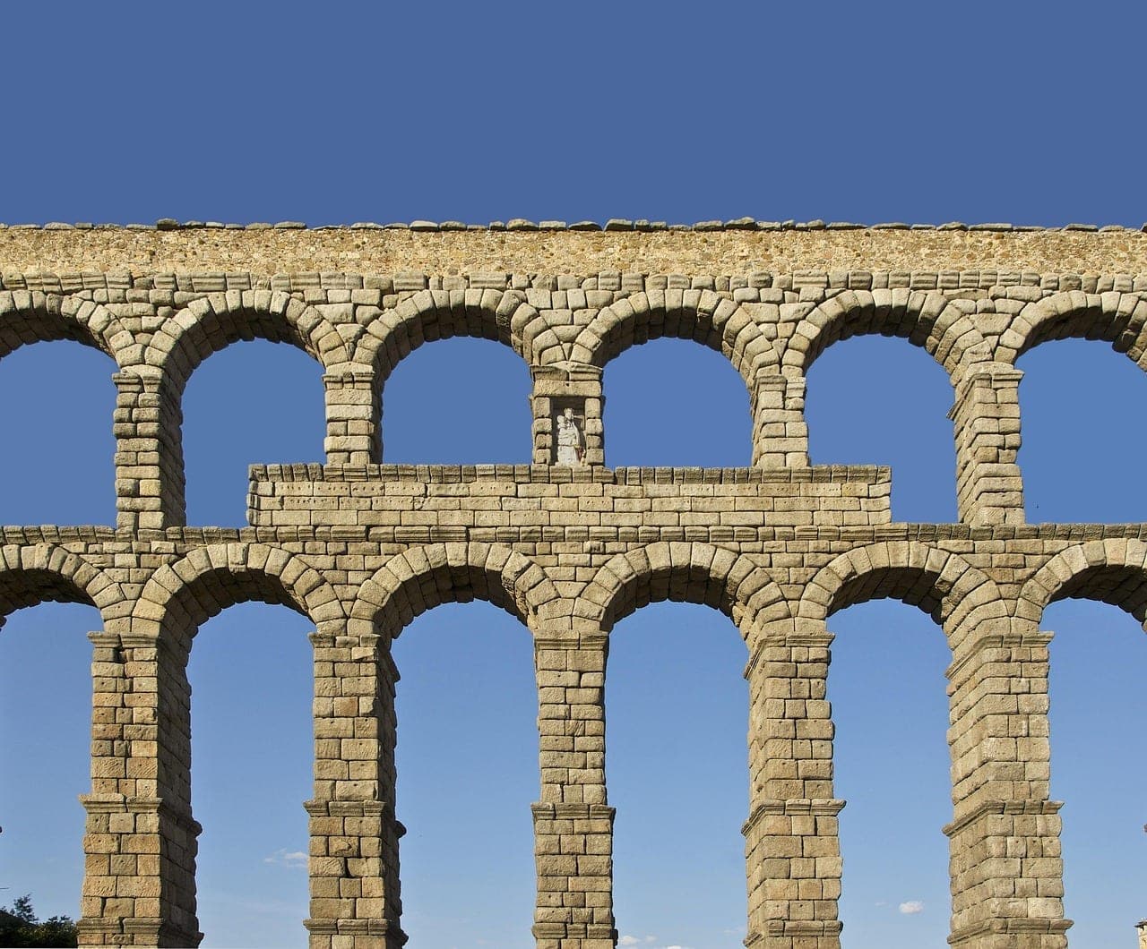 The Roman aqueduct of Segovia spanning the central plaza in Castile, Spain