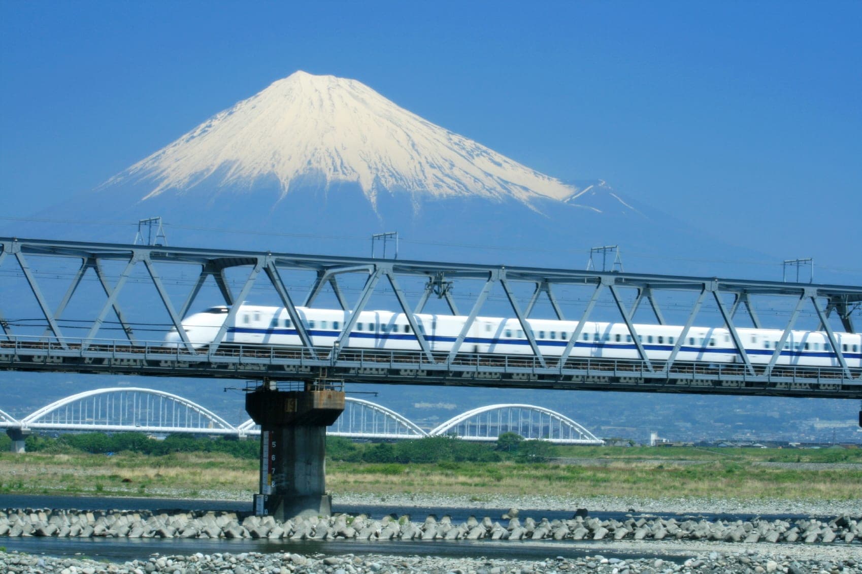 A Shinkansen bullet train passing in front of Mt. Fuji
