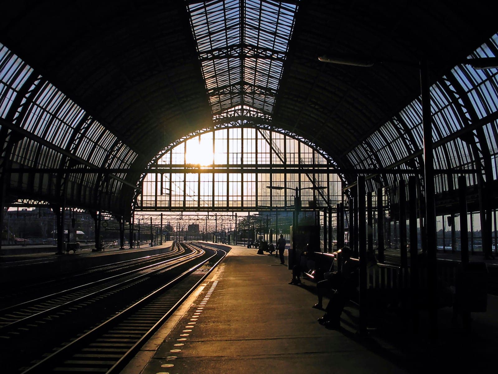 Amsterdam Centraal at golden hour — the platform where a packed-light trip begins